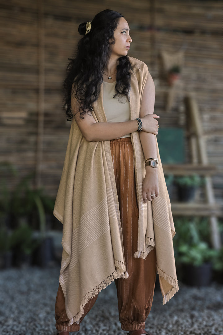Drape Cape – Sand Beige worn open over striped pants, front view