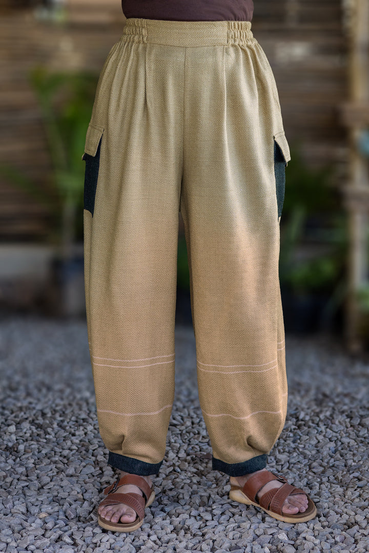 Drift Pant – Oatmeal, front view: pleated waist, dark contrast side pockets and cuffs